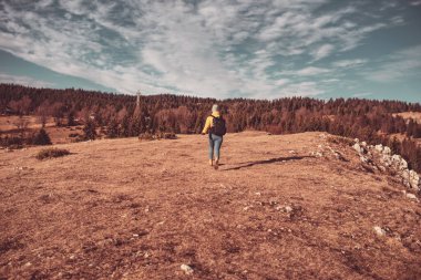 girl with a backpack hikers on a sunny day
