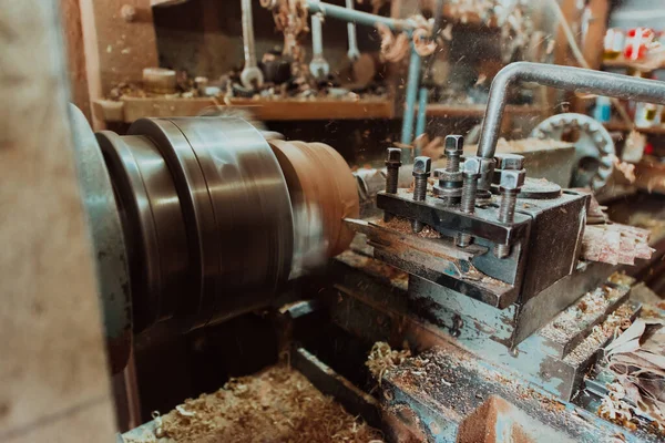 Close-up photo of a lathe working on wood. Mechanical processing of wood.