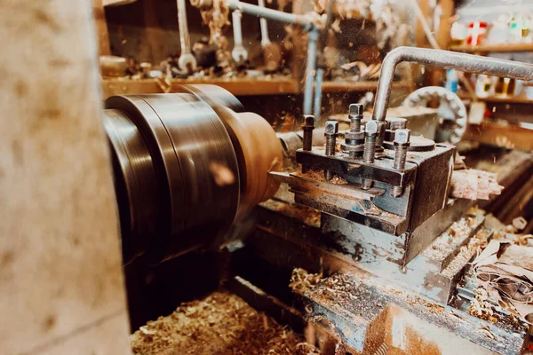 Close-up photo of a lathe working on wood. Mechanical processing of wood.