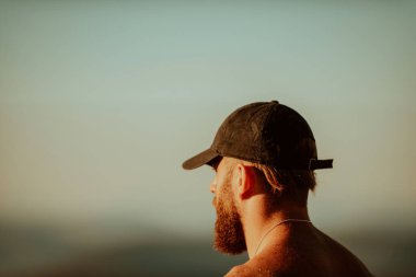 An athlete rests on top of a mountain after exhausting running training