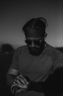 A determined athlete preparing for the start of training on the top of the mountain at sunrise