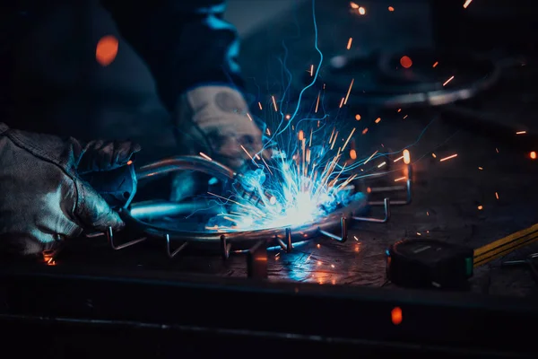Close up of the steel welding process. Work in the heavy steel industry.