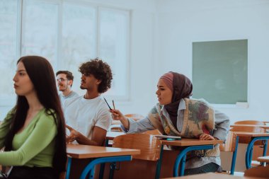 Çeşitli öğrencilerden oluşan bir grup, modern bir sınıfta kendilerini eğiterek, işbirliği ve bilgi alışverişinin gücünü kucaklayarak, canlı bir tartışmaya girişiyor.