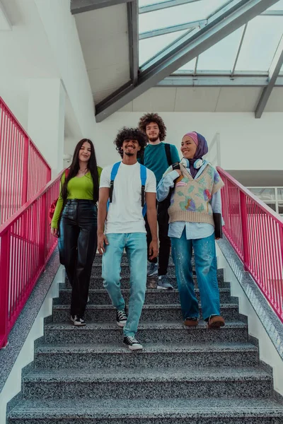 A group of diverse students, including an African American man and a Muslim girl wearing a hijab, walk together through the modern hallways of the university, symbolizing inclusivity and the power of