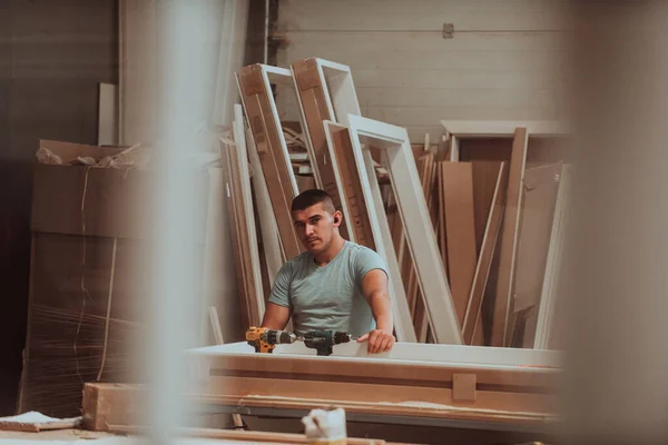 A skilled worker in the woodworking industry adeptly utilizes modern machinery to process and prepare wooden doors for the market, showcasing a seamless blend of traditional craftsmanship and cutting