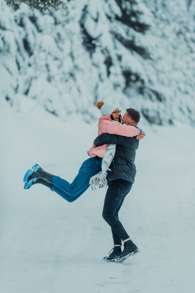 On a snowy Valentines Day, this romantic couple shares warmth, laughter, and tender embraces, creating a blissful winter love story