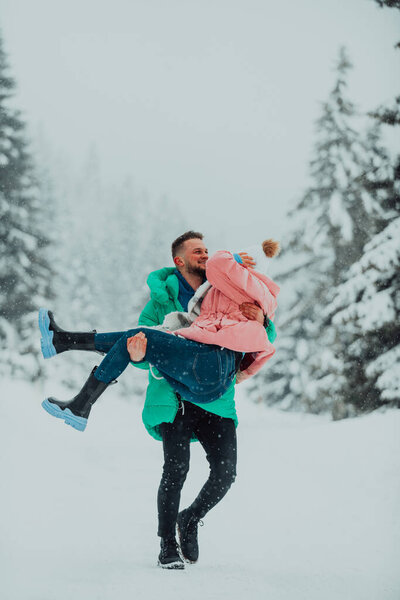 In a snowy Valentines Day embrace, this amorous couple revels in playful joy, laughter, and affection, crafting sweet memories in the winter wonderland of love. 