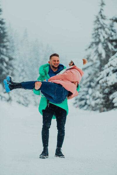 In a snowy Valentines Day embrace, this amorous couple revels in playful joy, laughter, and affection, crafting sweet memories in the winter wonderland of love. 