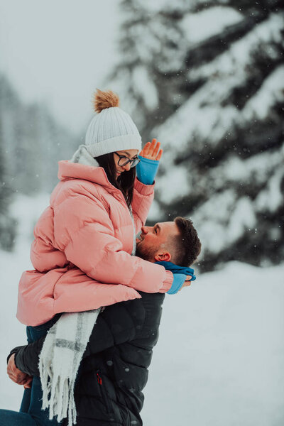 On a snowy Valentines Day, this romantic couple shares warmth, laughter, and tender embraces, creating a blissful winter love story
