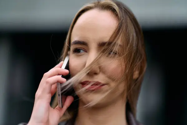 Business Woman With Phone Near Office. Portrait Of Beautiful Smiling Female In Fashion Office Clothes Talking On Phone While Standing Outdoors. Phone Communication