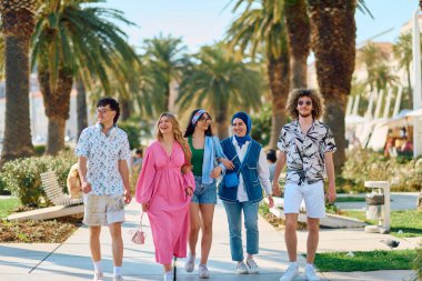 Yaz kıyafetleri içinde çeşitli turist grupları, geniş tebessümleriyle turistik şehirde geziniyor, gezintilerinin tadını çıkarıyorlar.. 