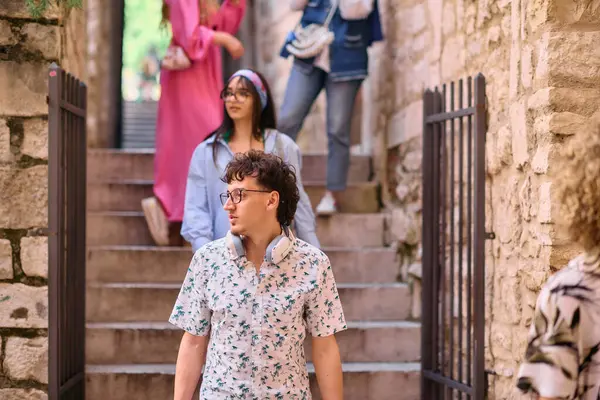 stock image A diverse group of happy tourists explores the charm and culture of a Mediterranean city, enjoying their summer vacation to the fullest