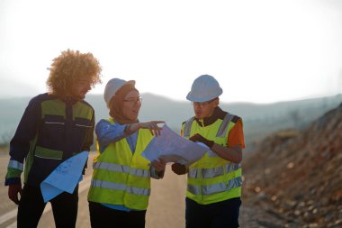 A team of engineers and workers oversees a wind turbine project at a modern wind farm, working together to ensure the efficient generation of renewable energy.  clipart