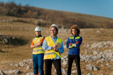 A team of engineers and workers oversees a wind turbine project at a modern wind farm, working together to ensure the efficient generation of renewable energy.  clipart