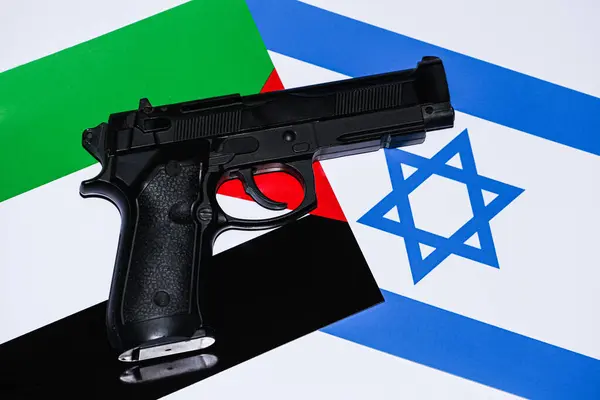 The conflict between Israel and Palestine is not over. The picture with the two flags that have a gun with a bullet on them, which shows us that there is a war between them. Stop war. Palestine war