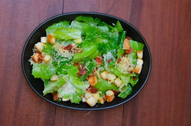 Caesar salad served with organic lettuce, crispy bread and sprinkled with cheese is a meal for health lovers.