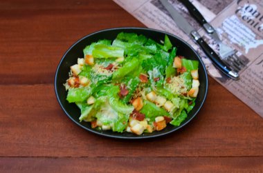 Caesar salad served with organic lettuce, crispy bread and sprinkled with cheese is a meal for health lovers.