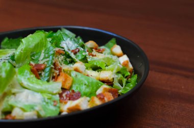 Caesar salad served with organic lettuce, crispy bread and sprinkled with cheese is a meal for health lovers.