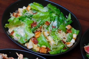 Caesar salad served with organic lettuce, crispy bread and sprinkled with cheese is a meal for health lovers.