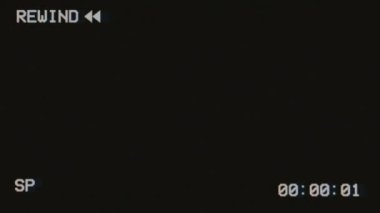 90s VHS animation, Reverse sign, arrow sign, VHS noise texture. Static noise, glitch effect. Video cassette recorder. Broken band type, bad signal. TV noise. Retro, on a black background