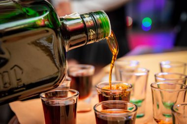 the drink that is poured into shot glasses