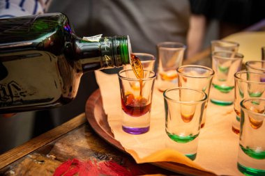 the drink that is poured into shot glasses