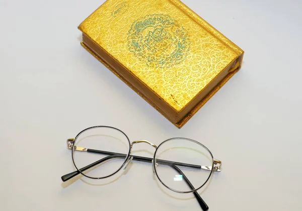 glasses and book on light background.