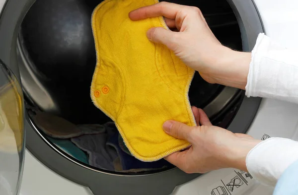 Female Hands Holding Yellow Cloth Pad Washing Machine Full Cloth — Stock Photo, Image