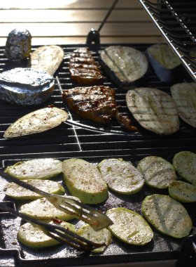 Baharatlı kabak, patlıcan dilimleri, folyodaki peynir, salamura edilmiş tavuk göğsü ve akşam ışıklarıyla alınmış ızgara maşası. Yaz yemeği. Ev yapımı gıda konsepti.