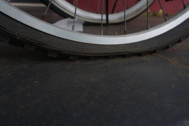flat bicycle tire in front of the house in the morning