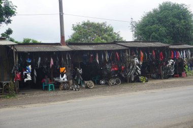 Bogor, Indonesia - February, 2023 : sellers of used motorbike spare parts and the like on the roadside, with cheap prices