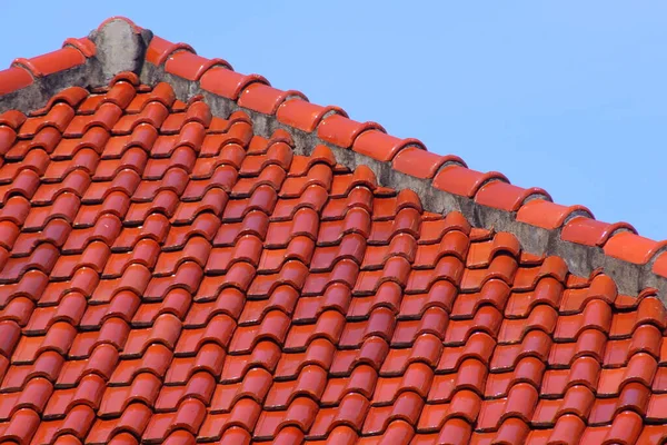 The roof of red tiles laid out