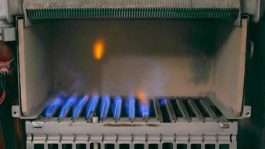 Gas ignition in the middle of the heating boiler. Heating with natural gas. Flammable and burning gas.