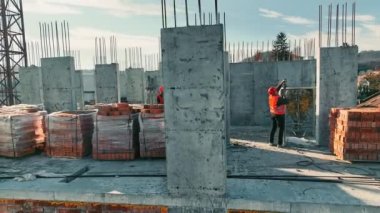 İnşaat işi. İnşaatçılar çok katlı tuğladan bir bina daha inşa ediyorlar.