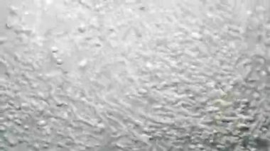 Su kabarcıkları Macro shot 'ı. Arkaplan Işıklandırılmış Hareket Baloncukları.
