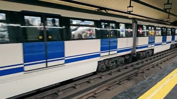 西班牙 马德里2912 2023等地铁到达车站时 站在月台上的人们像一列白色的地铁列车一样 拖着充满活力的车站艺术品进入地铁站 — 图库视频影像