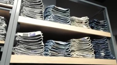 Mağazalardaki katlanmış kotlar, perakende mağazasındaki raflarda düzgünce katlanmış kotlar kot pantolonlar renklerine ve boylarına göre düzenlenir..
