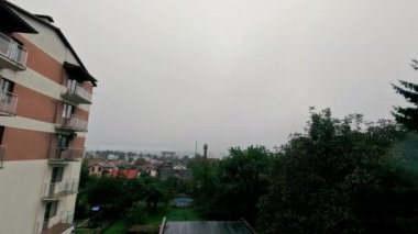 Apartman ve ağaçlarla kaplı bulutlu bir banliyö manzarası, bir apartman binasının bulunduğu banliyö mahallesine bakan bulutlu bir gün.