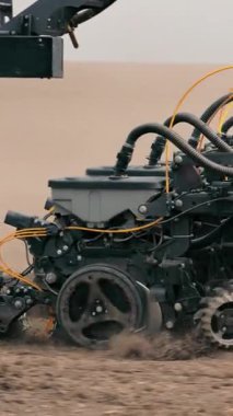 Tohum ekici, ekili bir tarlada çalışan tarım makinelerinin detaylı bir görüntüsü karmaşık ekipmanlar toprağı ekime hazırlıyor.