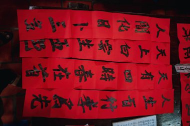 Vung Tau, Vietnam JAN 23 2022: Vietnamese scholar writes calligraphy at Long Son. Calligraphy festival is a popular tradition during Tet holiday. Writing couplets for Spring Festival at Luna new year