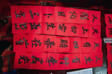 Vung Tau, Vietnam JAN 23 2022: Vietnamese scholar writes calligraphy at Long Son. Calligraphy festival is a popular tradition during Tet holiday. Writing couplets for Spring Festival at Luna new year