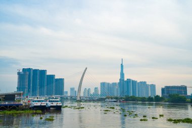 Ho Chi Minh city, Vietnam - FEB 12 2022: skyline with landmark 81 skyscraper, a new cable-stayed bridge is building connecting Thu Thiem peninsula and District 1 across the Saigon River.