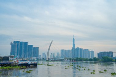 Ho Chi Minh city, Vietnam - FEB 12 2022: skyline with landmark 81 skyscraper, a new cable-stayed bridge is building connecting Thu Thiem peninsula and District 1 across the Saigon River.