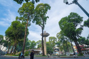 Wide angle view of Lotus pillar - An iconic architecture at Turtle lake (Ho Con Rua) with blue sky in Saigon.