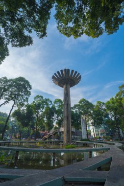 Wide angle view of Lotus pillar - An iconic architecture at Turtle lake (Ho Con Rua) with blue sky in Saigon.