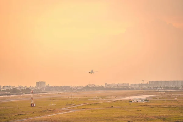 Ho Chi Minh city, Vietnam - FEB 12 2022: Airplane fly over urban areas preparing landing into Tan Son Nhat International Airport and takes off in TSN airport