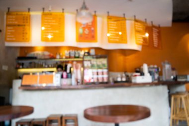 Blurred background Interior of cozy coffee shop. Contemporary design in loft style, modern dining place and bar counter, copy space.