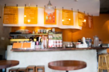 Blurred background Interior of cozy coffee shop. Contemporary design in loft style, modern dining place and bar counter, copy space.