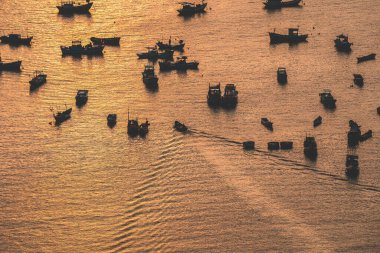 Aerial view many local culture Vietnam. Top view of local fisherman boats in the deep blue sea, tropical seascape. Travel destination Asia concept and background.