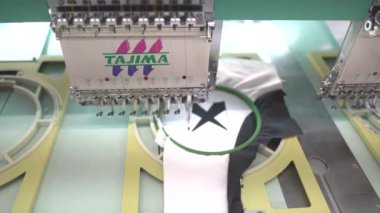 Ba Ria, VIETNAM - MAR 18 2022: Modern and automatic high technology sewing machine for textile or clothing apparel making manufacturing process in industrial. Close up Computerized embroidery machines